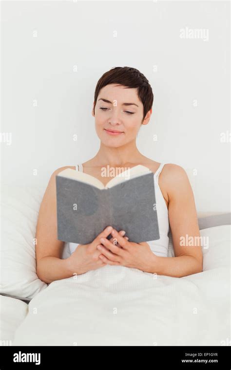 Smiling Brunette Reading A Book Stock Photo Alamy