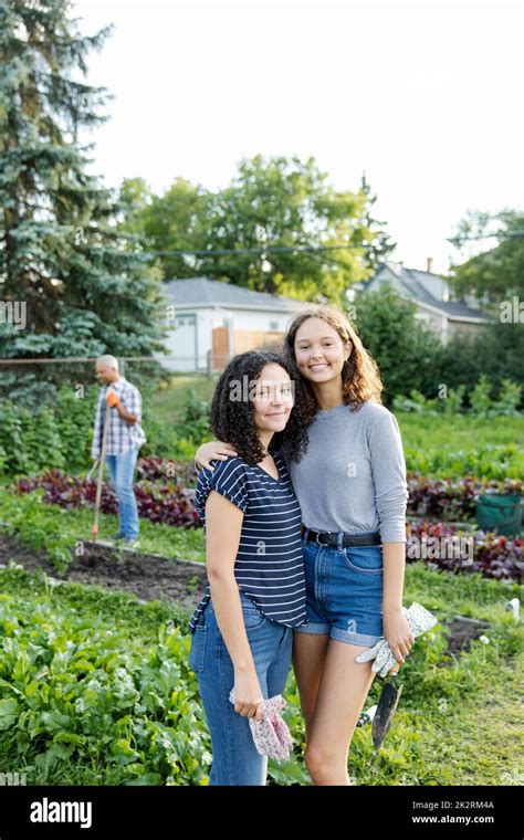 Portrait Of Sisters In Community Garden Stock Photo Alamy