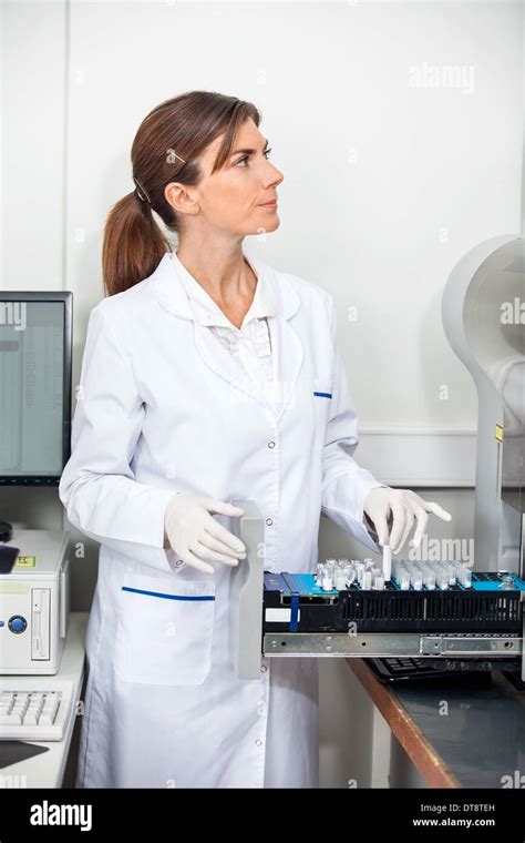 Researcher Loading Samples In Coagulation Analyzer Stock Photo Alamy