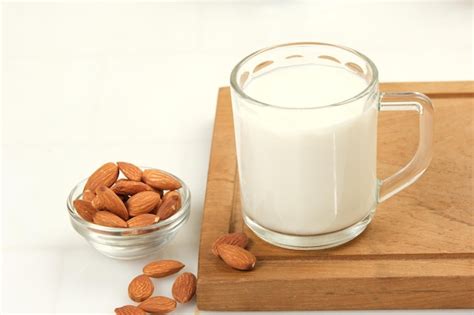 Premium Photo A Glass Of Almond Milk With Almond On Light Background