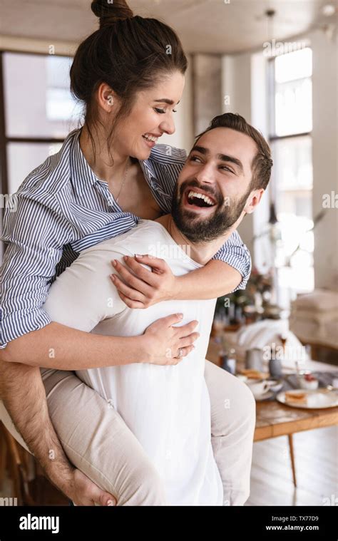 Photo Of Playful Brunette Couple In Love Man And Woman 20s Smiling