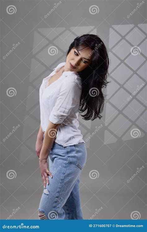 A Beautiful Brunette Woman In A Casual Outfit In The Studio Stock Image