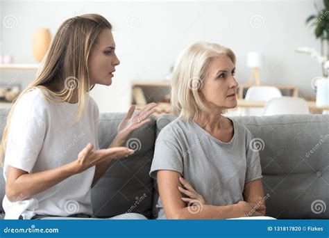 Annoyed Adult Daughter Arguing With Stubborn Old Mother Ignoring Stock