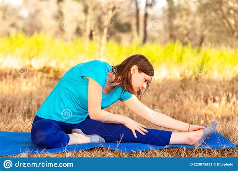 Young Woman Doing Stretching Exercises Into The Forest Pregnant Woman