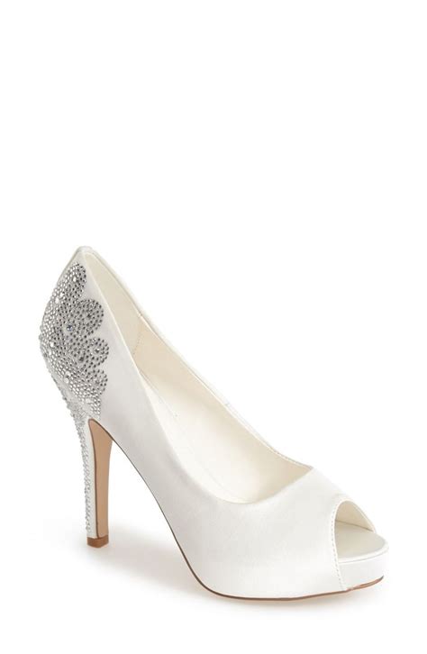 A Women S White High Heeled Shoe With An Embellishment