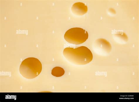 Cheese with holes Stock Photo - Alamy