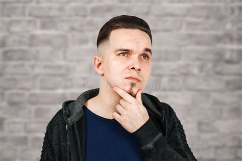 Thinking Guy Holds Hand At Face Closeup Portrait Of Young Pensive Man