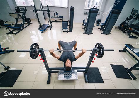 Bodybuilder Trainer Man Doing Bench Press Workout In Gym Photo From