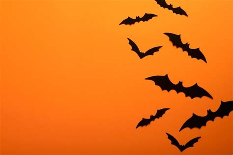 Premium Photo Orange Halloween Background Flock Of Black Bats For