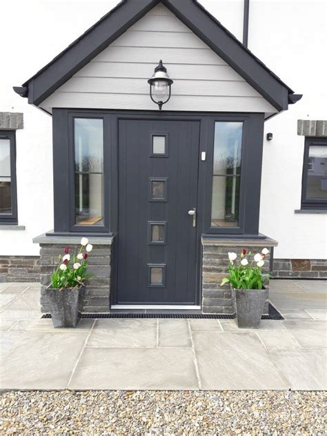 Anthracite Composite Front Door And Marley Cedral Cladding In Light Grey On New Build House