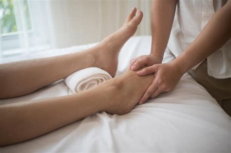 Premium Photo Midsection Of Woman Giving Massage To Customer Lying On Bed In Spa