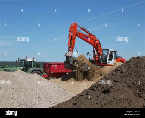 Shovel Excavator Loading A Dump Lorry With Earth On A Building Site