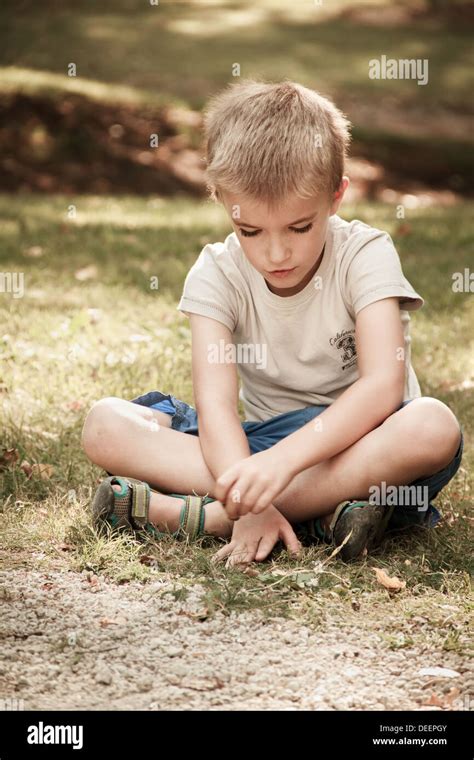 Boy Years Sitting On Grass Stock Photo Alamy