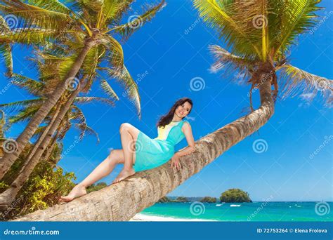 Young Beautiful Asian Girl On The Palm Tree On A Tropical Beach Stock