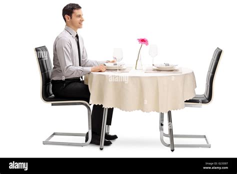 Young Man Sitting At A Restaurant Table And Waiting For His Date