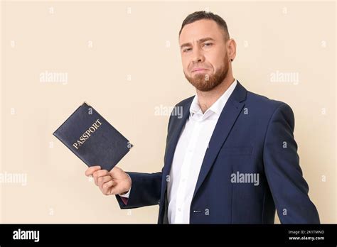 Businessman With Big Passport And Tickets On Light Background Stock