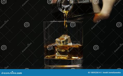 Pouring Whiskey Cognac Into Glass Black Background Pour Of Alcohol