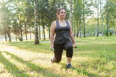 A Charming Brunette Woman Plus Size Body Positive Practices Sports In