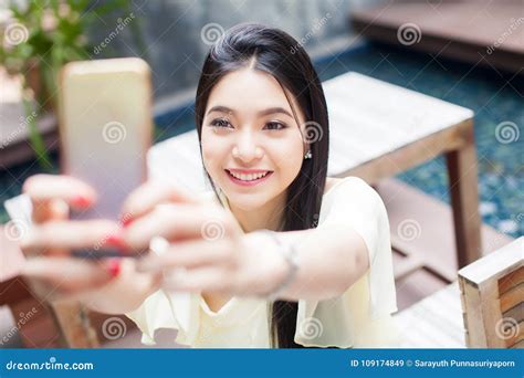 Asian Woman Taking A Selfie With Her Phone In Public Park Focus Stock