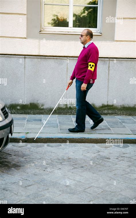 A young woman helps a blind man cross the road Stock Photo - Alamy