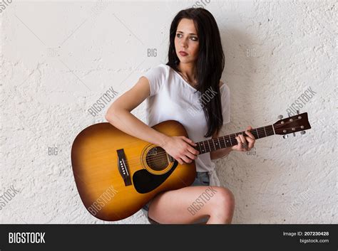 Woman Playing Acoustic Guitar