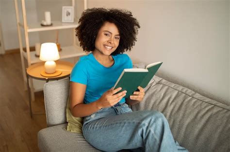 Premium Photo Smiling Millennial Curly Black Lady Reading Book