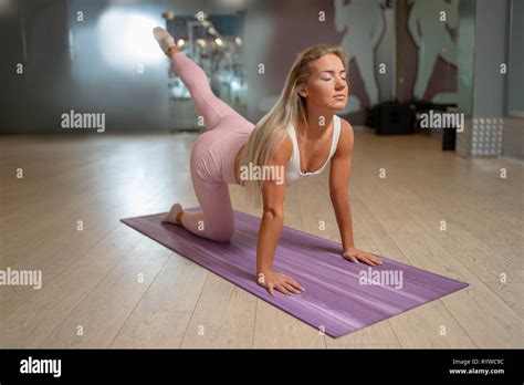 Blonde Woman Standing On All Fours On Mat Doing Yoga Stock Photo Alamy