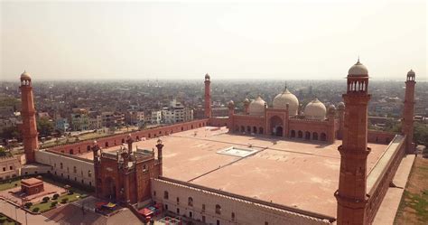 Badshahi Mosque Main Courtyard With The Minarets In Carved Red