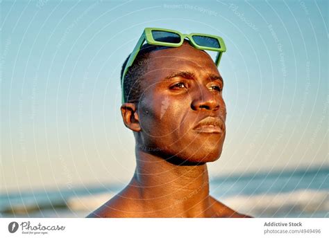 Pensive Shirtless Black Man In Sea Water A Royalty Free Stock Photo