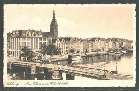 An Old Photo Of A River With Buildings In The Background And A Bridge