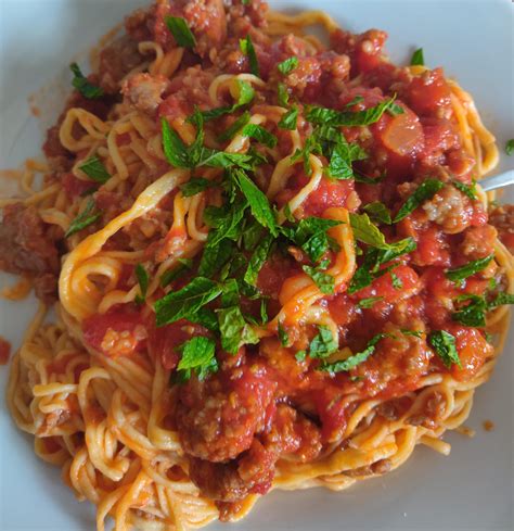 Homemade Spicy Italian Sausage Ragu Fresh Spaghetti Topped With Mint