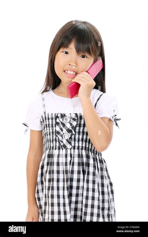 Happy Smiling Little Asian Girl Calling By Cellular Phone Stock Photo