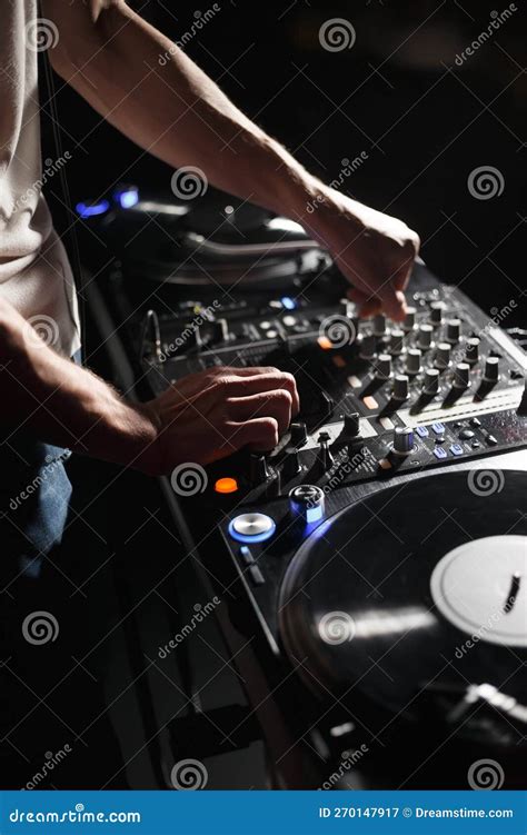 Techno DJ Plays Set With Vinyl Turn Table And Sound Mixer In Night Club