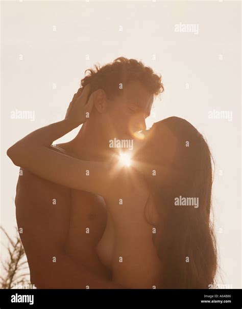 Nude Couple Embracing At Sunset Stock Photo Alamy