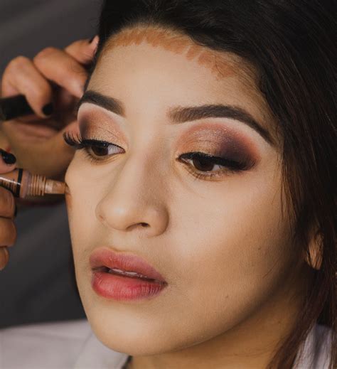 Woman With Black Hair Doing Her Makeup · Free Stock Photo