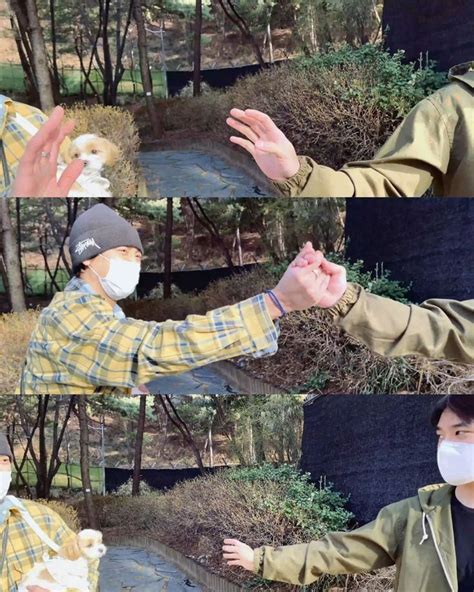 Two People Wearing Face Masks And Holding Hands Out In Front Of Trees