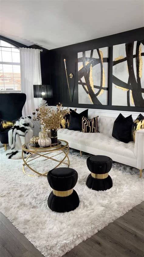 A Living Room With Black And White Furniture Gold Accents And