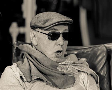 Premium Photo Close Up Of Senior Man In Sunglasses And Cap Making Face While Sitting On Chair