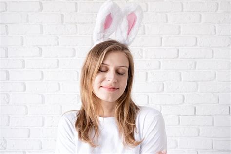 Premium Photo Portrait Of A Happy Woman In Bunny Ears On White Brick