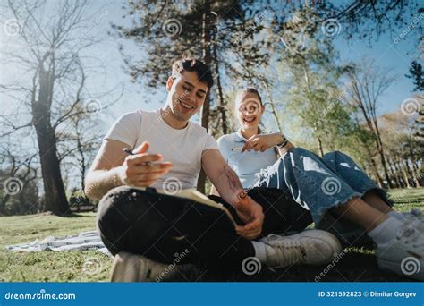 High School Students Studying Together Outdoors On A Sunny Day