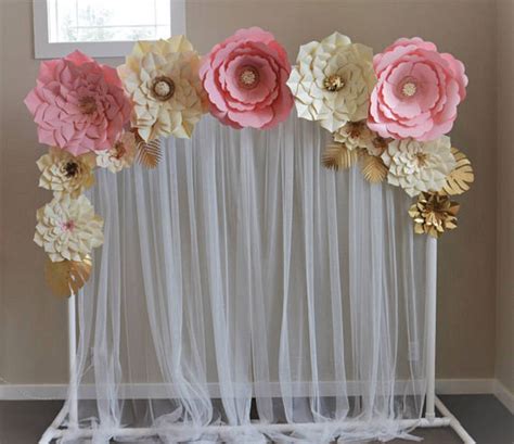 An Arrangement Of Paper Flowers Is Displayed In Front Of A Window With