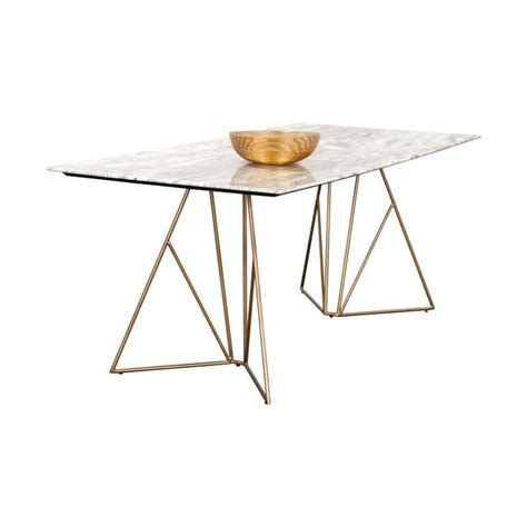 A Marble Table With Metal Legs And A Golden Bowl On Top Against A