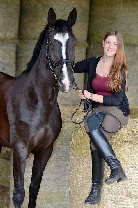 Girl In Breeches And Black Leather Riding Boots With Her Horse