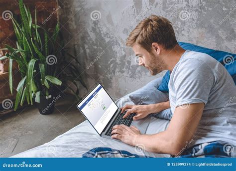 Young Man in Bed Using Laptop with Facebook Editorial Stock Image ...