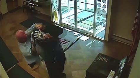 Surveillance Video Shows Customer Tackle Armed Bank Robber