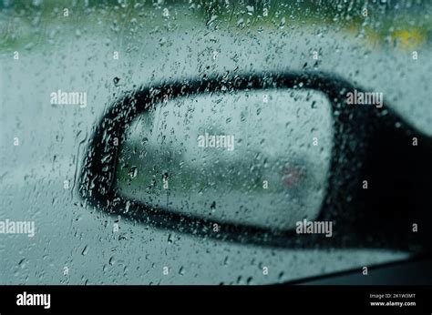 Driving Car On Road In The Rain With Raindrop Over The Wind Shield