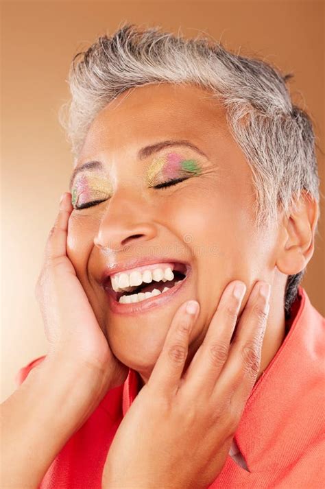 Happy Color And Senior Woman With Makeup Standing In A Studio With