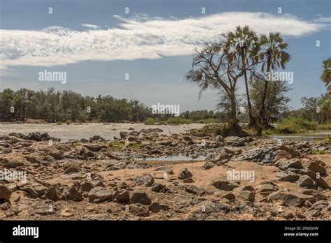 Landscape View Of The Kunene River The Border River Between Namibia