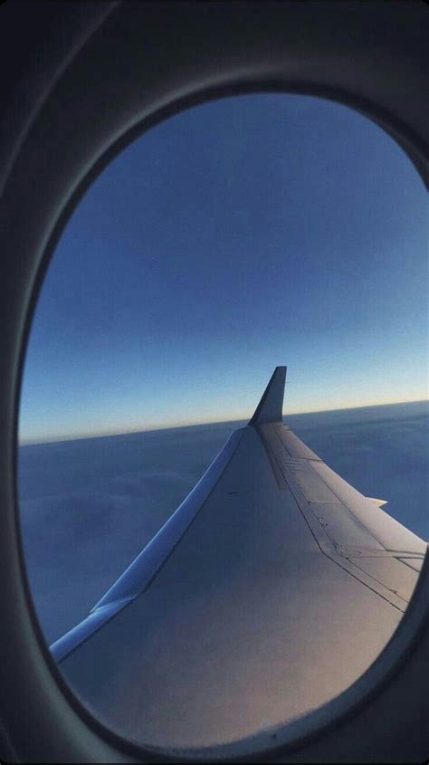 The Wing Of An Airplane As Seen Through A Round Hole In The Plane S Window