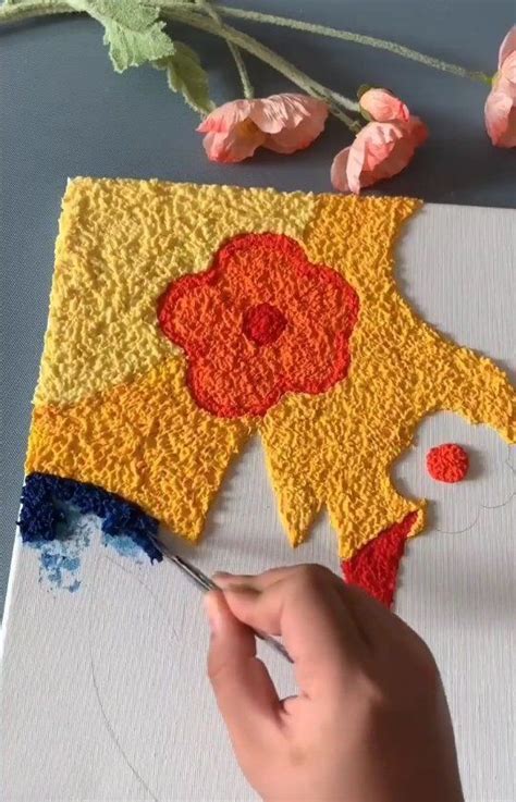 Someone Is Painting A Flower On A Piece Of Paper